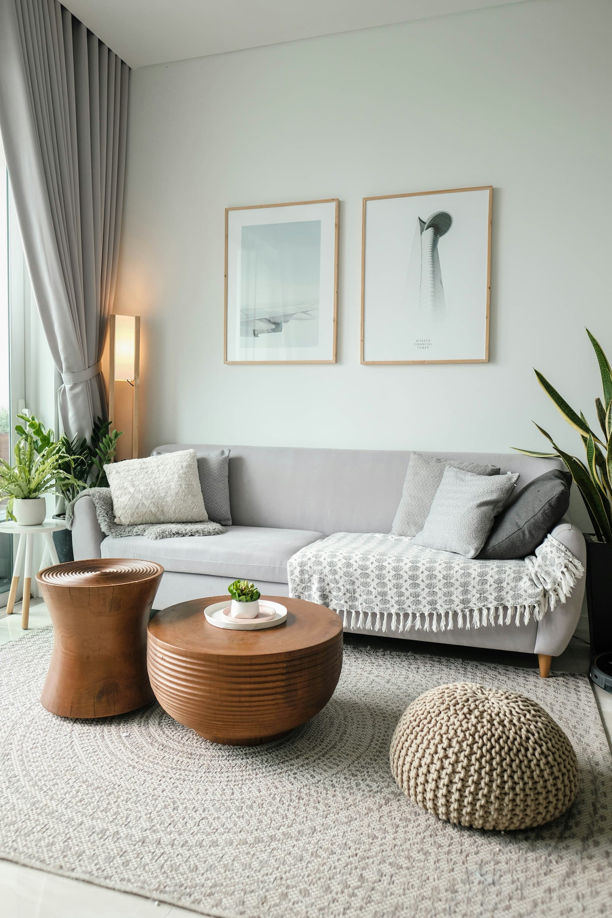 A calm living room with a grey sofa and warm lamp light